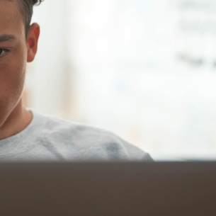 Teenage boy using AI to complete his homework