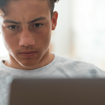 Teenage boy using AI to complete his homework
