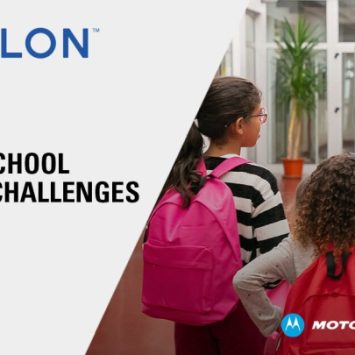 Three school children wearing rucksacks