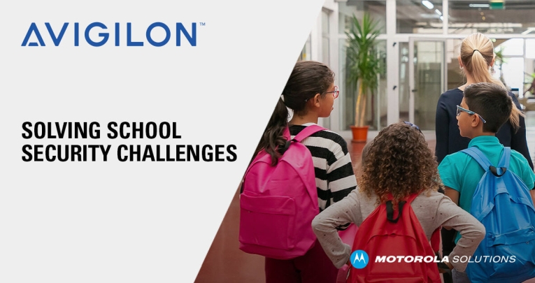 Three school children wearing rucksacks