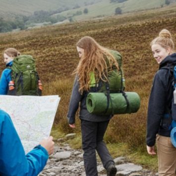 A group of students hiking with rucksacks