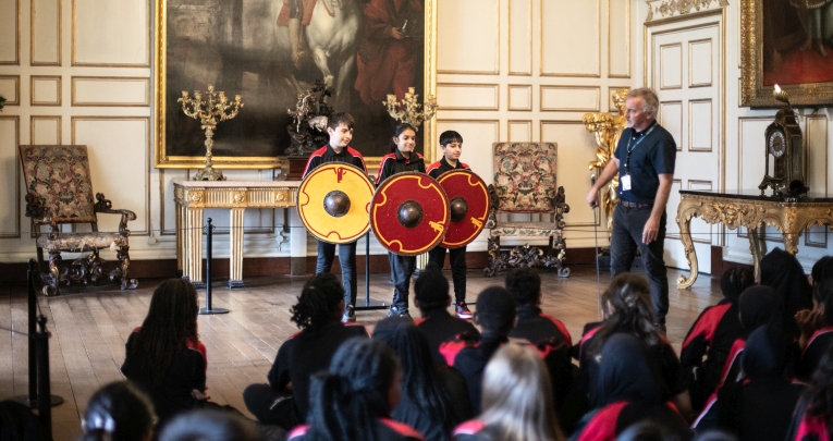 School pupils holding Saxon shields at Warwick Castle
