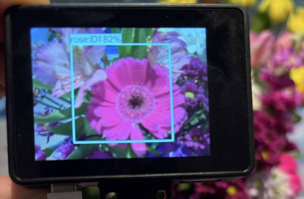 The HuskyLens 2 AI Vision Sensor identifying a flower