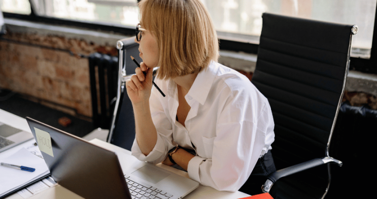 Teacher using laptop to do marking with AI