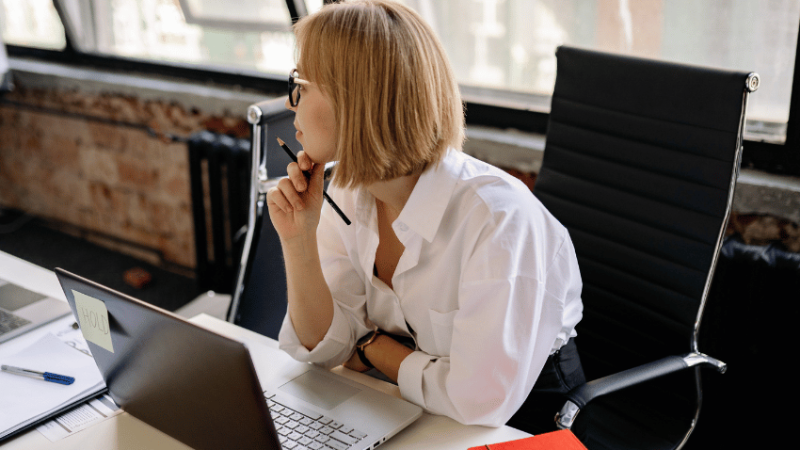 Teacher using laptop to do marking with AI